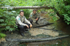 Park Rangers at the source of Brim River Hot Springs, in prime Grizzly Bear habitat (note the can of bear spray). The hot springs bubble out of the stream bed gravel at about 56° C.